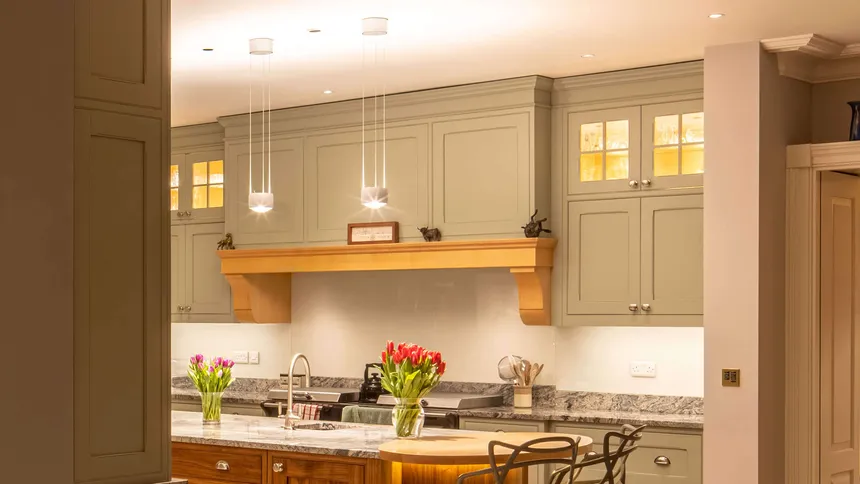 Pendants and discreet downlights lighting a kitchen island