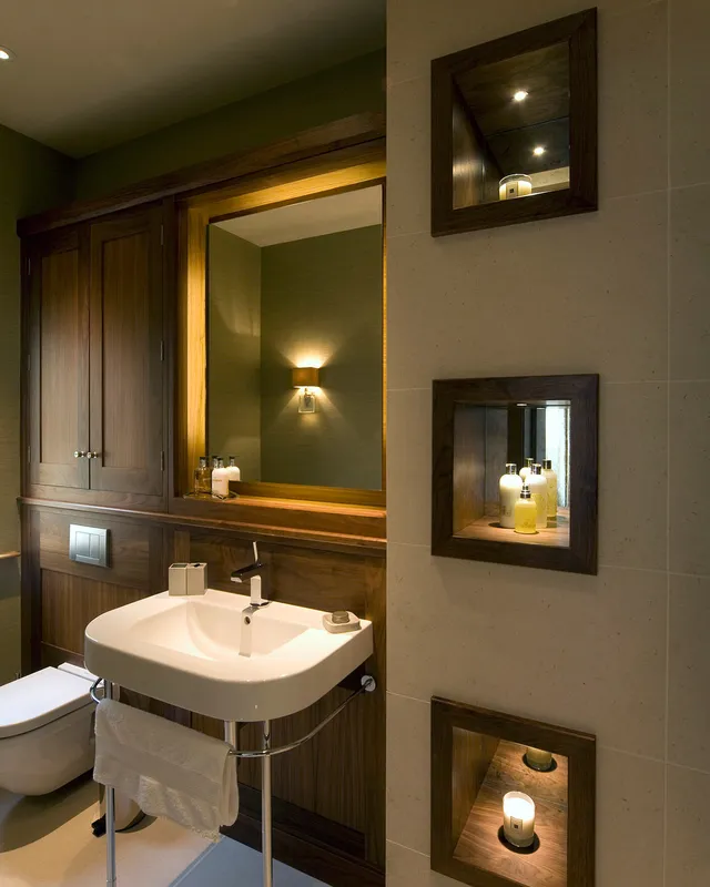 Lit niches and a mirror with diffuse backlighting add magic to a luxurious bathroom