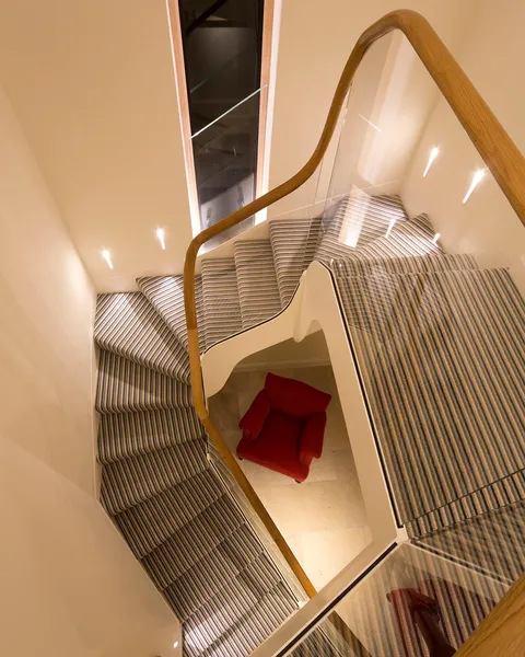 Looking down on a modern staircase with LED accent lighting shining onto the treads