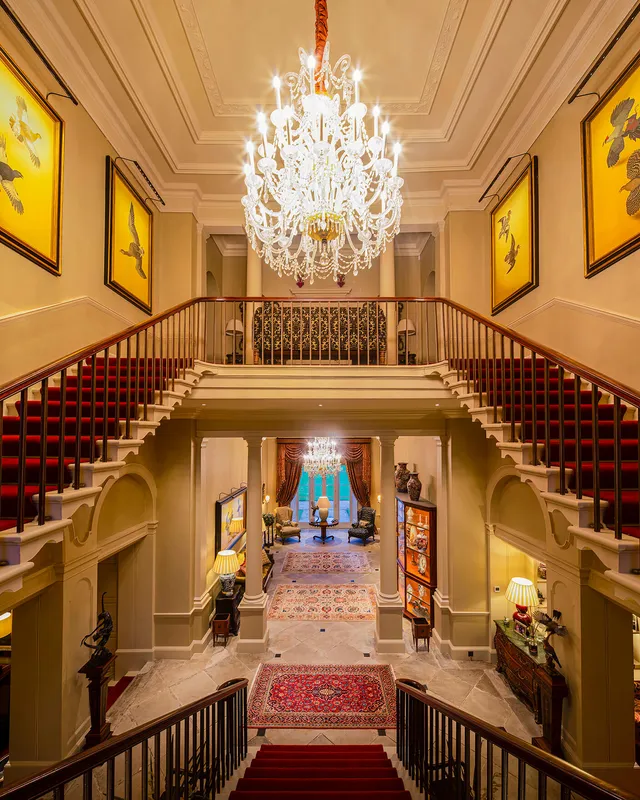 Large chandeliers and bespoke ArtView pciture lights in a splendid hallway and staircase