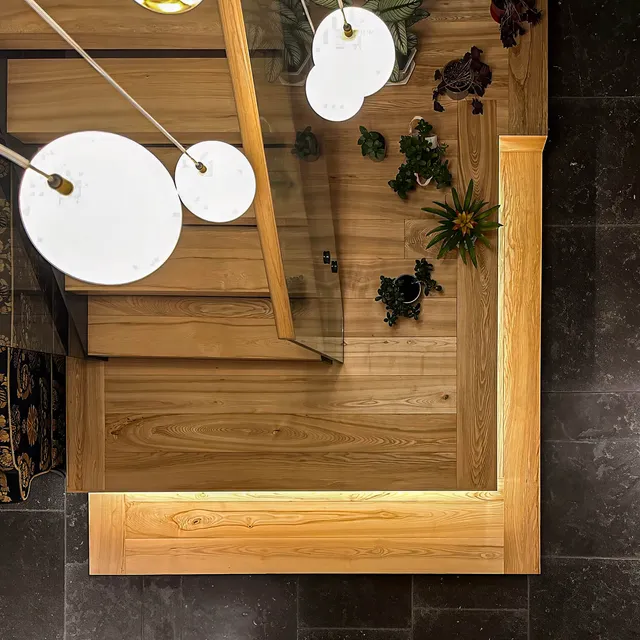 Top down view of an underlit timber staircase