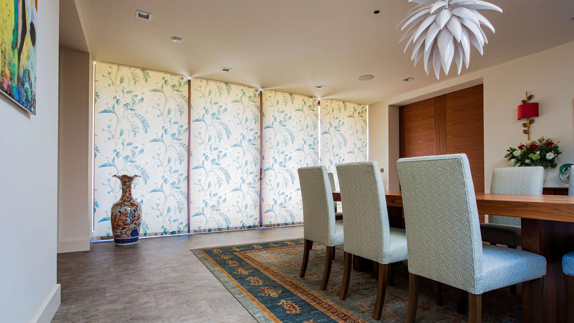 Lutron electric blinds lowered in a modern dining room on a bright, sunny day