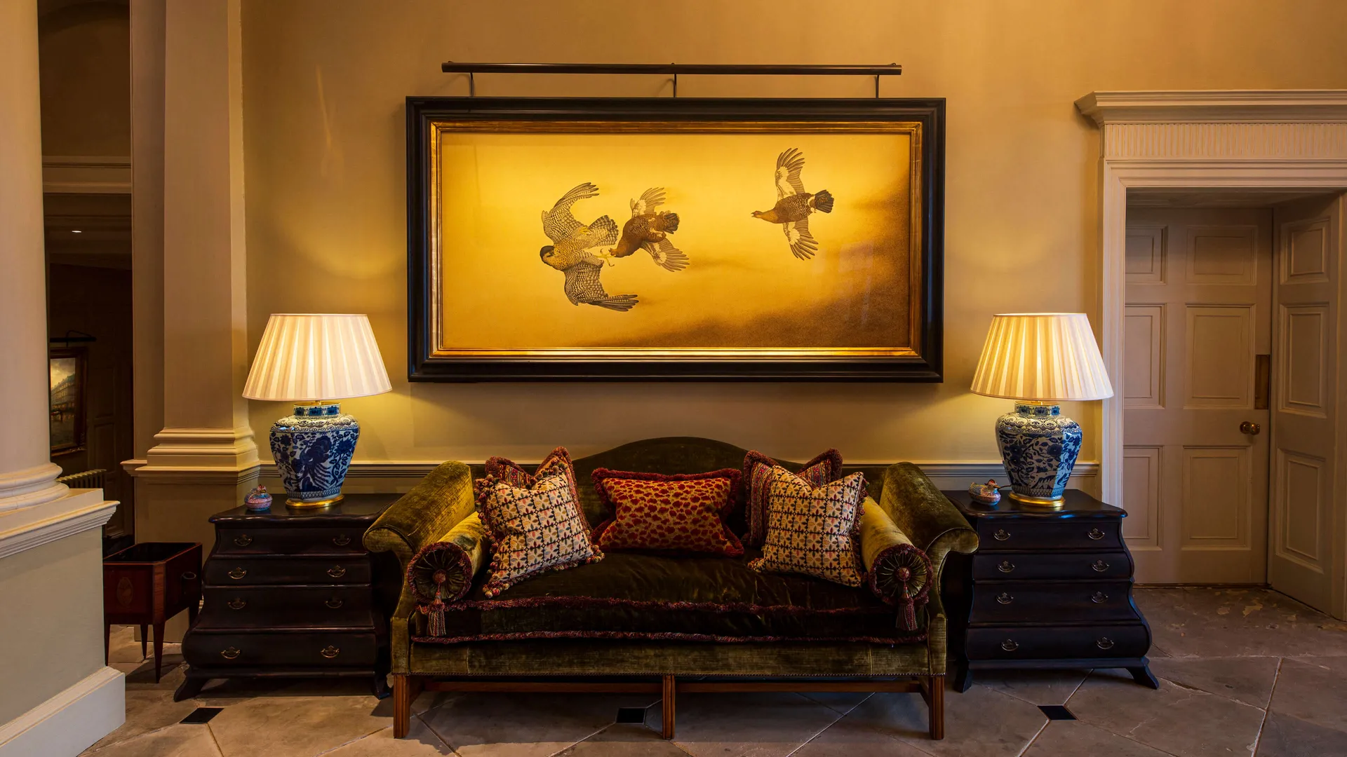 A large silk painting lit with an ArtView LED picture light in an English country house