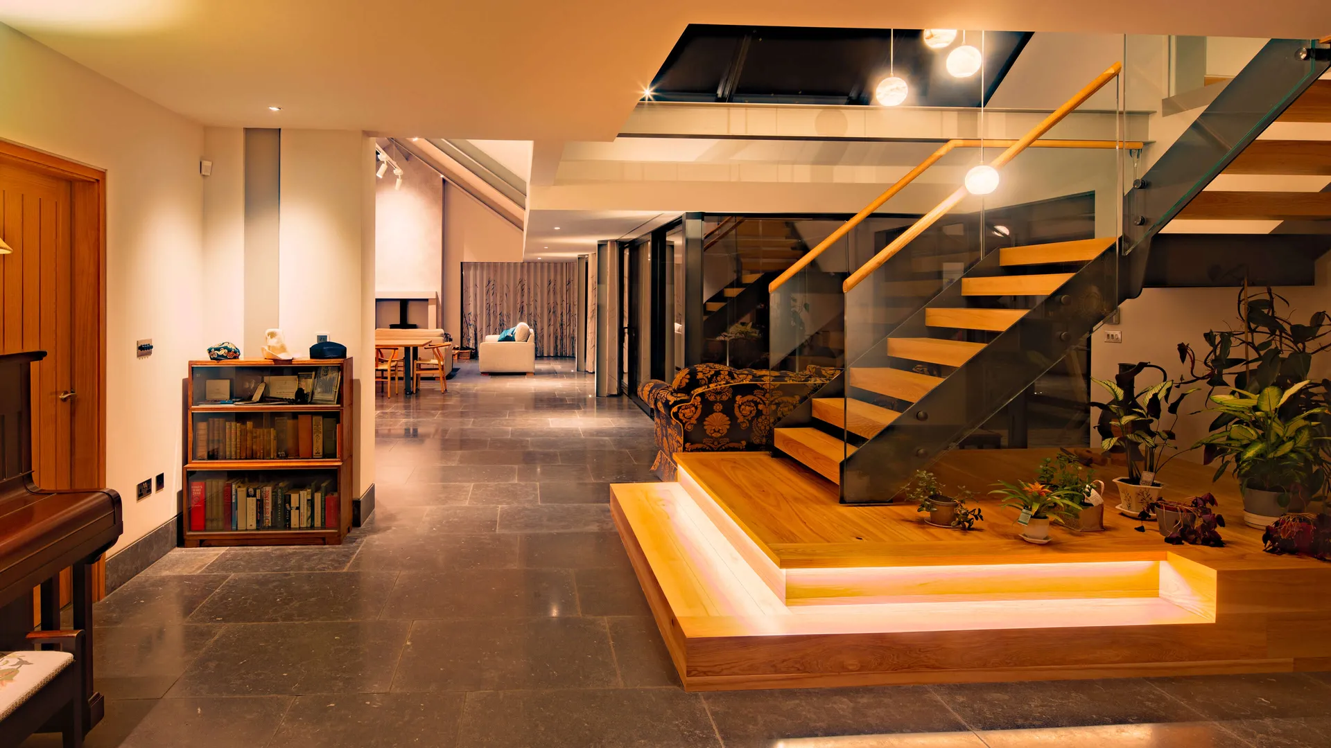 Underlit stairs in a modern new-build looking towards the living room