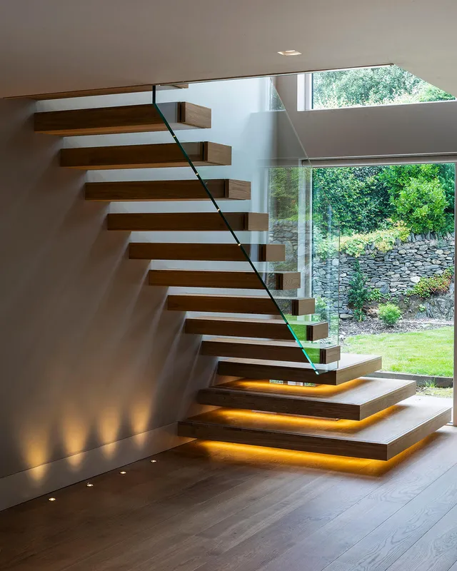 Underlit treads and uplighting under a cantilevered staircase