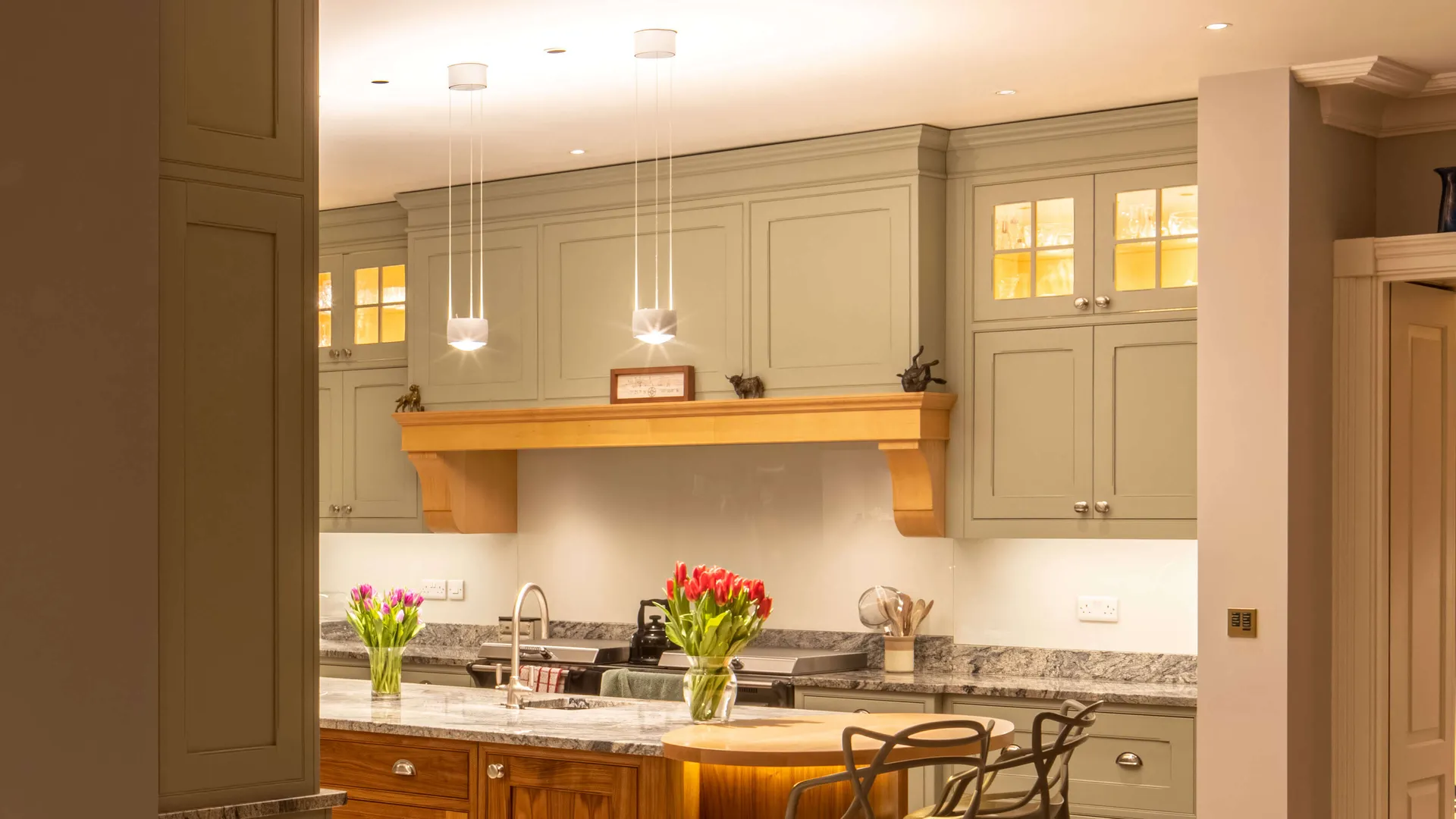 Pendants and discreet downlights lighting a kitchen island