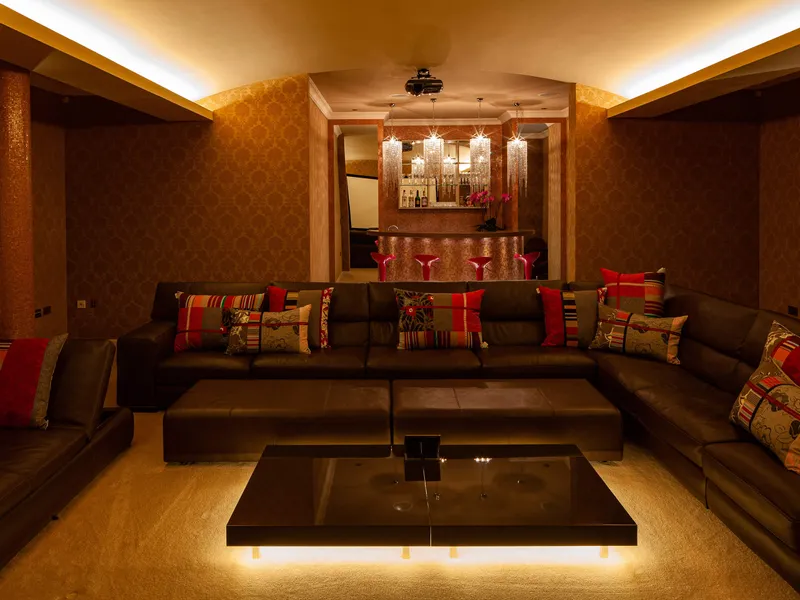 A home cinema and bar with a barrel ceiling lit with a was of cold cathode