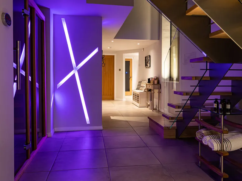 Colour changing recessed linear LED lighting in a new-build house, purple