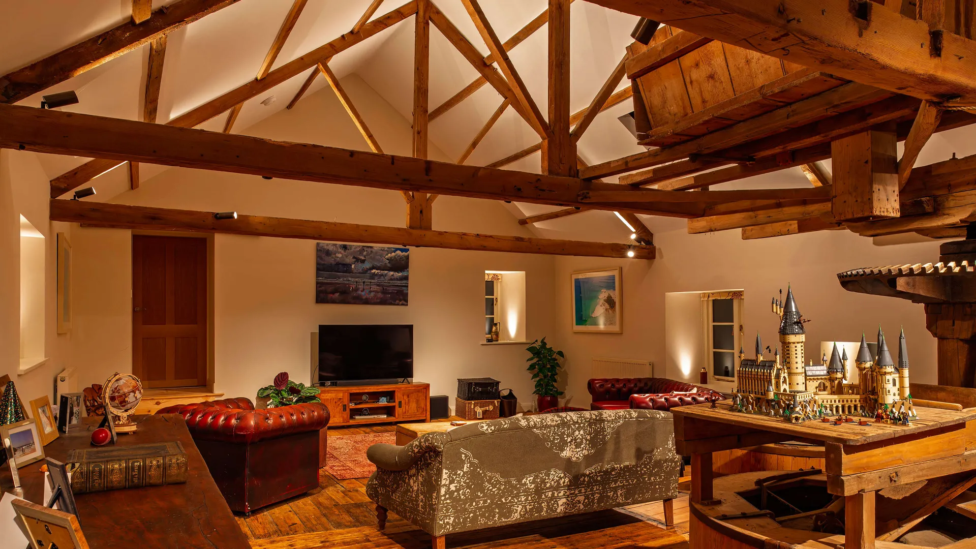 Cosy lounge setting with exposed beams and a pitched ceiling